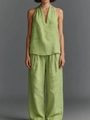 Detail of green sleeveless v-neck top and wide-leg trousers set with linen texture - Matcha Green