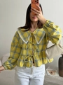 Detailed view of yellow plaid blouse with lace collar and three front bow ties - S / Yellow