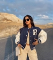 Close-up of navy varsity jacket featuring a white towel-embroidered R letter patch - S / Navy Blue