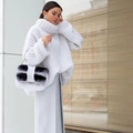 Detailed view of heavy ribbed knit texture on a cozy white chunky turtleneck sweater - White
