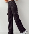 Detailed side view of high-waisted black cargo pants with contrasting white stitching - Black & White