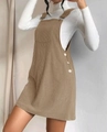 Detail view of brown corduroy pinafore dress with decorative side buttons and metal buckles - S / Khaki