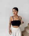 Close-up of a black ruffled crop top paired with elegant white high-waist wide-leg pants - S / Black
