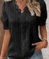 Detail of V-neck crochet lace trim and textured vertical pleats on a black blouse - S / Black