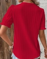 Close-up of the fine pleated texture and ruffle short sleeve on this red summer blouse - Red