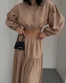 Detailed close-up of khaki long-sleeve tie-up top and tiered maxi skirt with puff sleeves - S / Camel