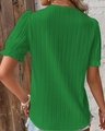 Macro shot of green pleated fabric texture and ruffled short sleeve cuff detail - Green