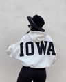 Detail of white oversized fleece hoodie featuring bold black IOWA printed on the back - S / White