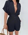 Detail view of black short sleeve romper featuring lapel collar and elastic waist texture - S / Black
