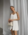 Close-up of white backless strap dress and beige handbag with woven handle in soft light - S / White