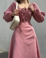 Detail of light pink square neck dress featuring smocked fabric and lantern sleeves - S / Pink