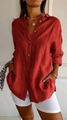 Detail view of red long-sleeved shirt with crinkled texture, lapel collar and side pockets - Red