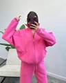 Detail of oversized bright pink fleece tracksuit featuring a hooded zipper and ribbed cuffs - S / Rose Red