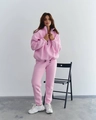 Detail of pink two-piece tracksuit featuring a half-zip stand collar and jogger pants - S / Pink