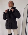 Detail of black quilted puffer jacket featuring a plush faux fur collar and belted waist - S / Black