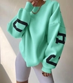 Detail of mint green sweatshirt featuring oversized black letter prints on sleeves - Emerald Green