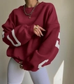 Detail of white geometric print on burgundy oversized sleeve with ribbed cuffs - Burgundy