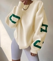 Detail of loose-fit beige sweatshirt with bold green letter print on the sleeve - Apricot