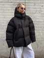 Detail of oversized black hooded puffer jacket with premium matte texture and warm filling - S / Tops / Black