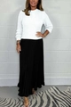 Detail view of a white knitted long sleeve sweater paired with a black pleated maxi skirt - White and Black
