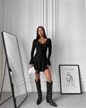 Detail of a slim fit black long sleeve dress featuring ruffle trim and a deep V-neckline - S / Black