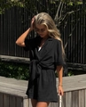 Detail of summer black two-piece set featuring short sleeve lapel shirt with knot and shorts - S / Black