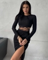 Detail view of black ribbed knit crop top with waist ties and side slit button skirt - S / Black