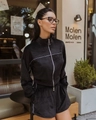 Detail of black velvet two-piece set featuring silver zipper and white contrast piping accents - S / Black