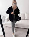 Close-up of a stylish quilted chain shoulder bag paired with a thick black shirt jacket - S / Black