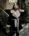 Detail of winter black long coat featuring white faux fur trim and matching waist belt - S / Black and White