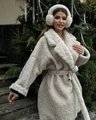 Detail view of cream faux fur coat featuring wide lapels and matching waist tie belt - S / White