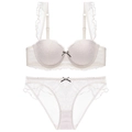 Detailed view of off-white lace lingerie set with ruffles and contrasting bows - 70A / White