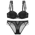 Detailed view of black lace lingerie set with ruffled straps and bow accent - 70A / Black
