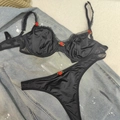 Black satin lace lingerie set with red rose details on casual denim backdrop - S / Black
