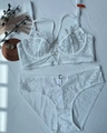 Flat lay of white French lace lingerie set with floral patterns and delicate straps - 70B / White
