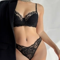 Sexy black lace lingerie set with French embroidery and thin straps on model - M / Top And Bottom / Black