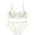 Close-up of intricate floral lace details and cross-strap design on a white bra set - 70A / Bra & Panty Set / White