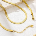 Detail of gold herringbone snake chain with lobster clasp and tiny heart charm pendant - Necklace / Gold