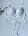 Flat lay of a white seamless lingerie set with sheer mesh and gold ring accents - 70B / White