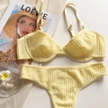 Detail of bright yellow lace lingerie set with adjustable straps on a stylish magazine - S / Top And Bottom / Yellow