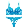 Flat lay of cyan blue sheer leaf embroidery lace bra and matching thong set - Light Blue