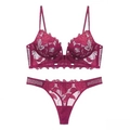 Detailed flat lay of deep burgundy lace lingerie set with V-neck bra and floral thong - Burgundy