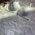 Elegant white lace lingerie set with push-up bra and matching panties on plush rug - 70B / White