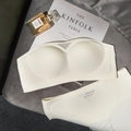 Seamless strapless beige bra and panties set on a soft textured fabric background - White Zirconia Set