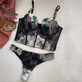 Detail of floral bustier set with black lace trim and golden chain strap accents - 70B / Top And Bottom / White
