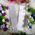 Close-up of clear anti-slip bra straps with metal hooks on decorative floral background - Grey Display Cards with Iron Buckle / Clear