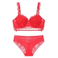 Detailed view of red lace lingerie set with mesh fabric and metal hardware accents - Red / 70C