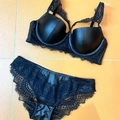 Detailed view of black lace and faux leather lingerie set laid flat on surface - 85B / Tops / Black