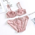 Pink lace lingerie set with floral embroidery and ruffle straps in a flat lay view - 70A / Top And Bottom / Lotus Pink
