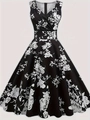 Détail d'une robe vintage noire avec imprimé floral et un col en V croisé élégant - S / Noir